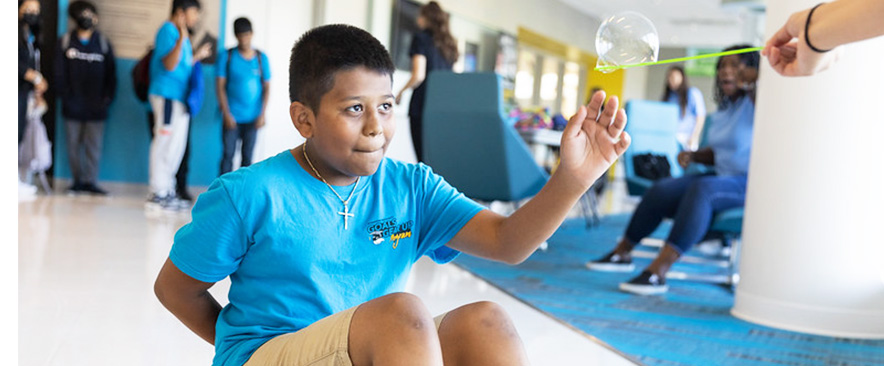 GOALS GEAR UP student in the middle of a science project