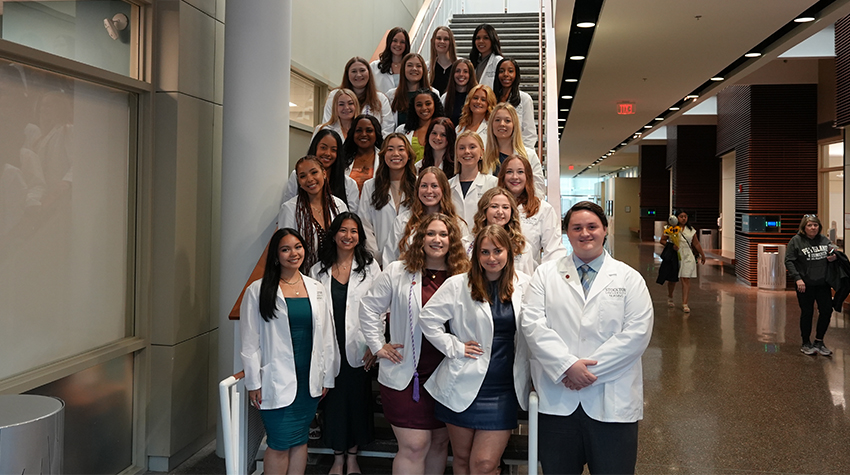 Nursing graduates on the stairs of the Campus Center