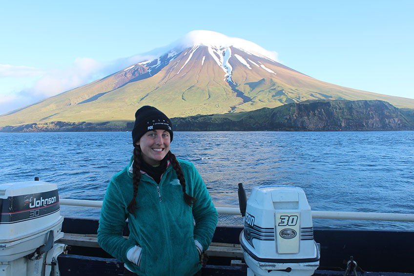 Bobbi Hornbeck during her fieldwork with Segula Volcano in the background, which is just one of the Aleutian Islands that her project takes place on. 