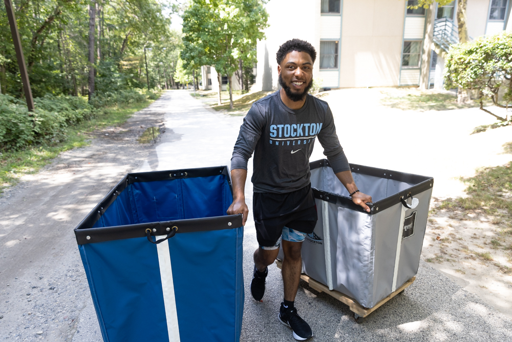 a student pushing move in carts