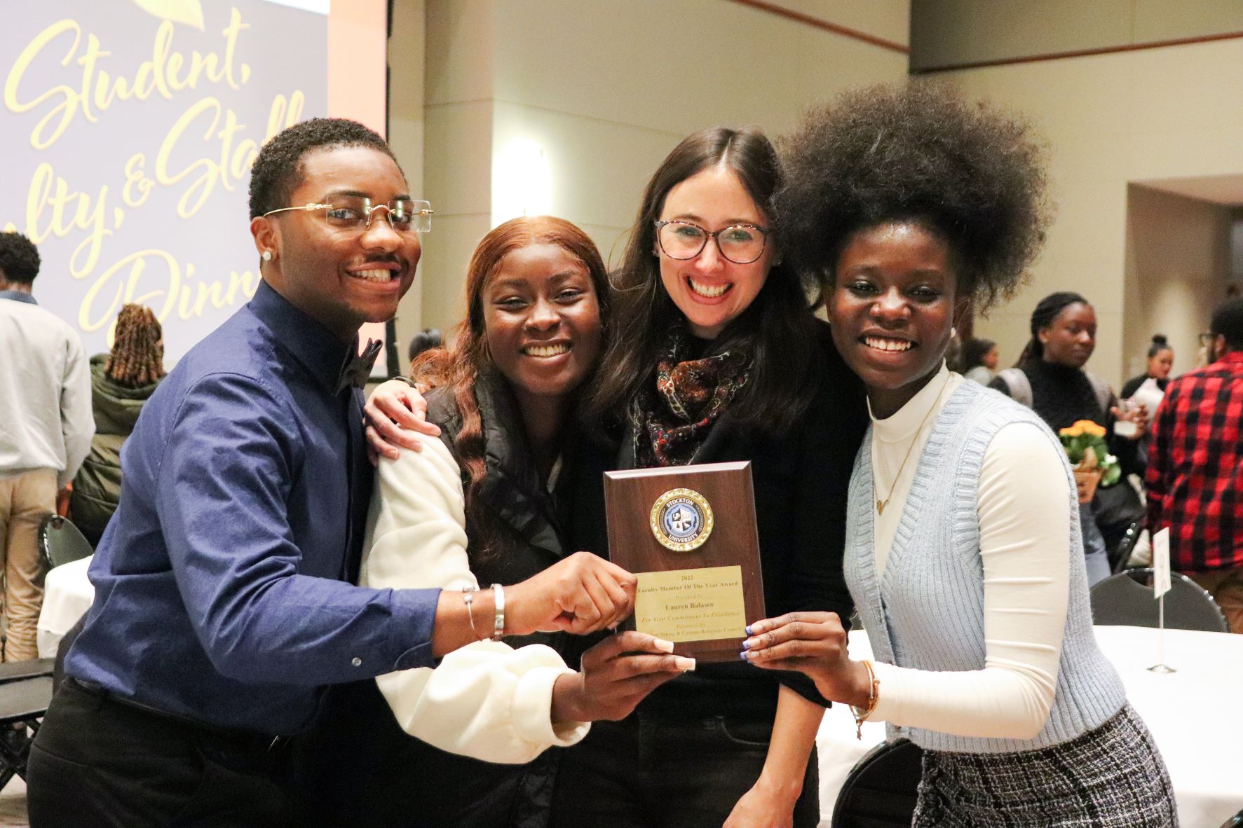 Assistant Professor of Political Science Lauren Balasco poses for a photo with her students after receiving the Faculty Member of the Year Award.