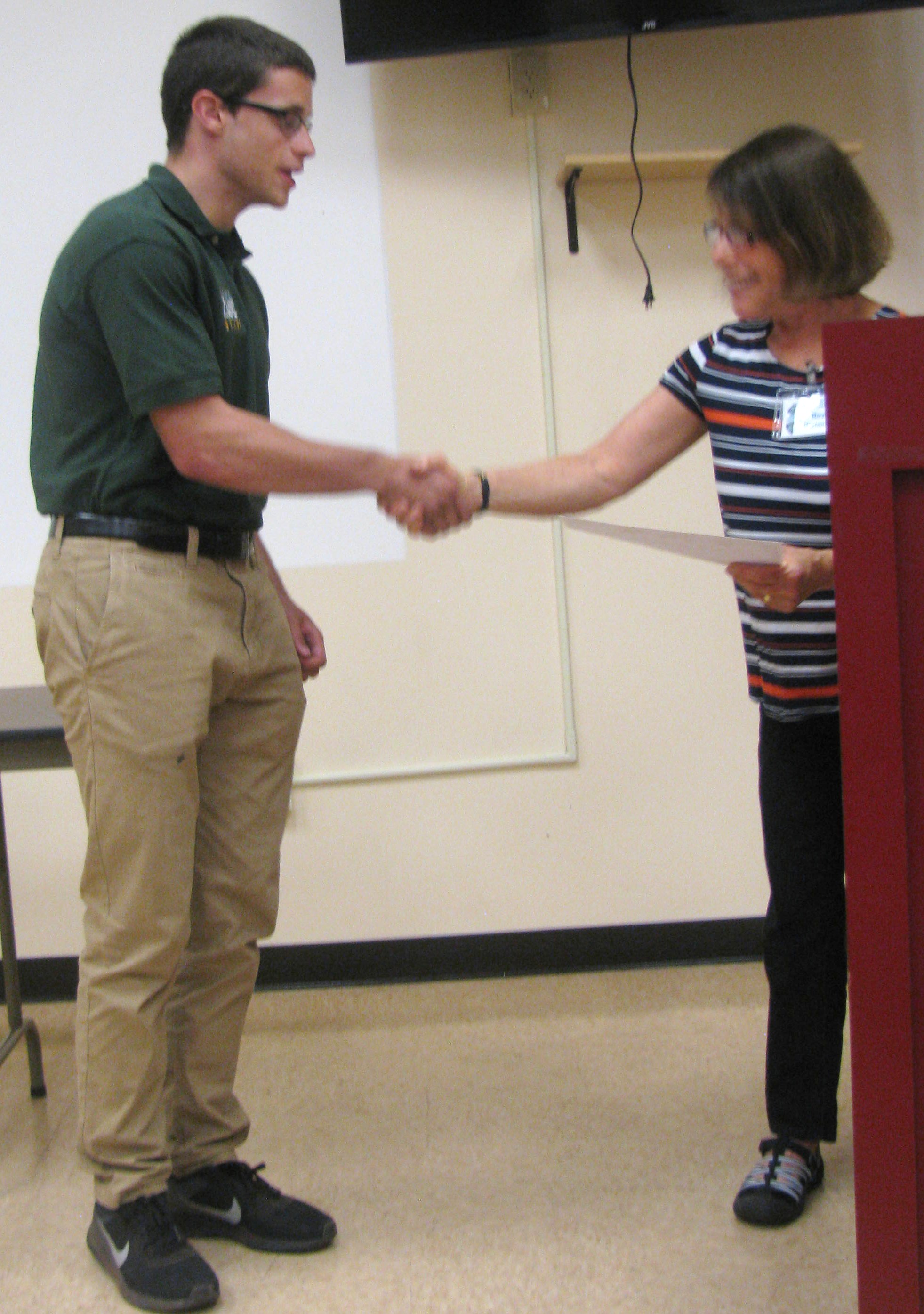 Alexander Melchiore receives the James F. Akers Memorial Conservation Scholarship from AAS member Roz Herlands. Photo credit: Charles Herlands