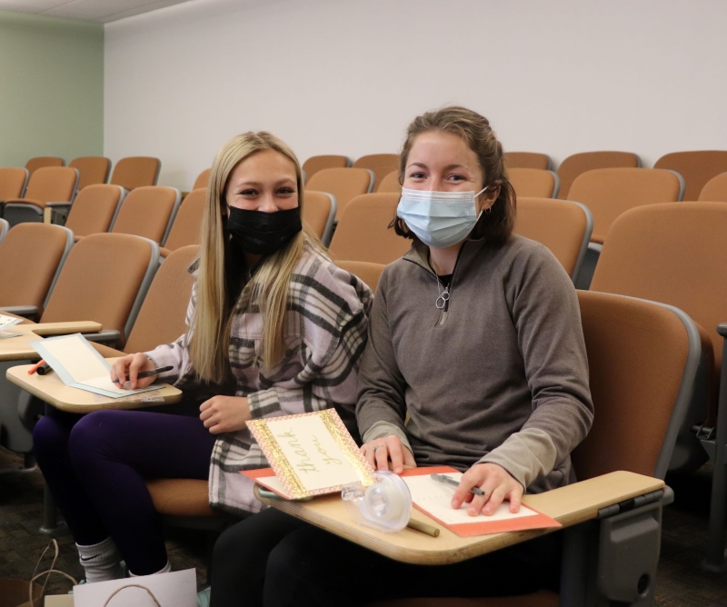 Stockton students Olivia Harris and Marlee Tharp write letters to active service members as part of Stockton's MLK Day of Service.