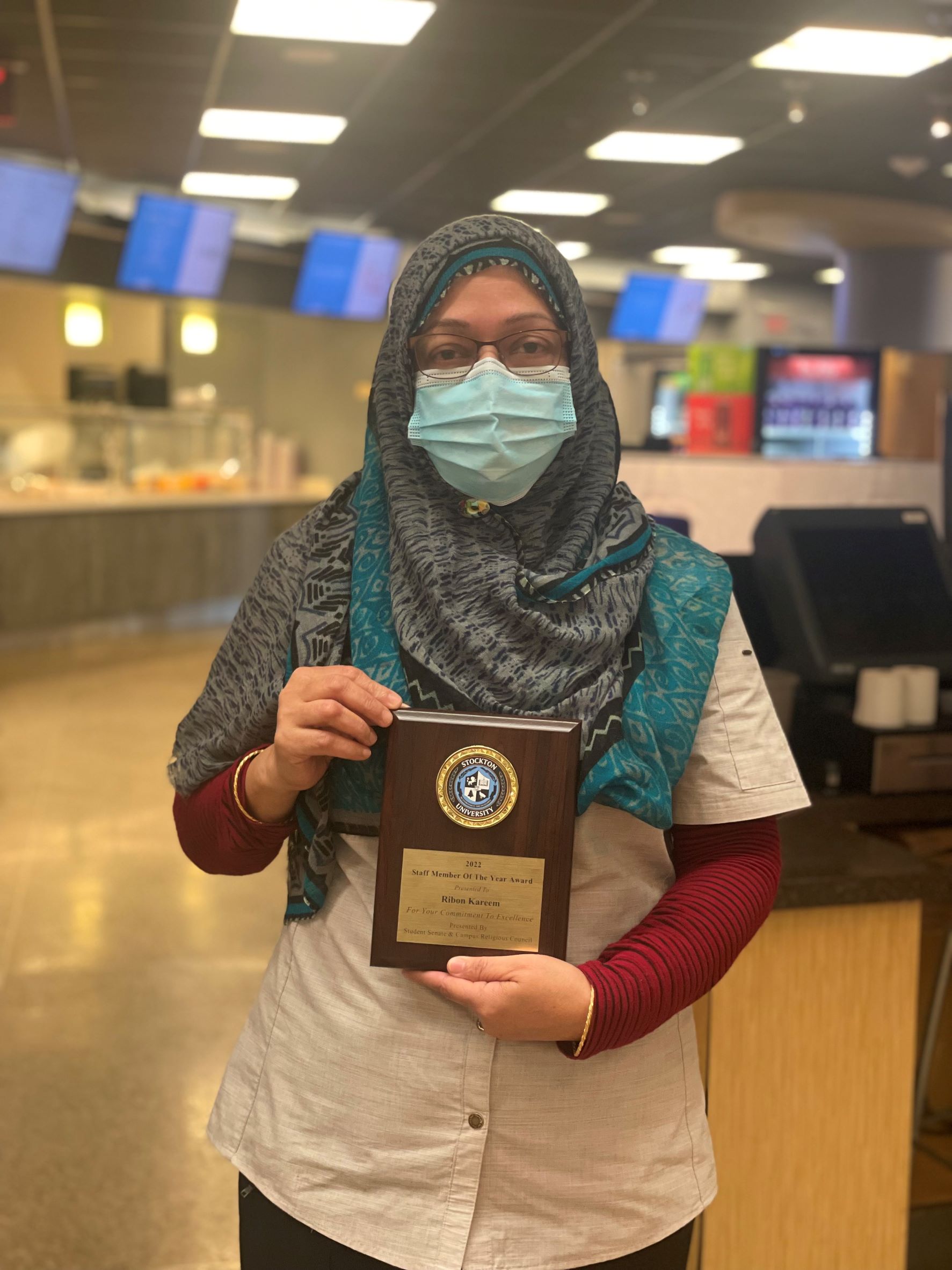 Robin Kareem poses with her Staff Member of the Year Award.