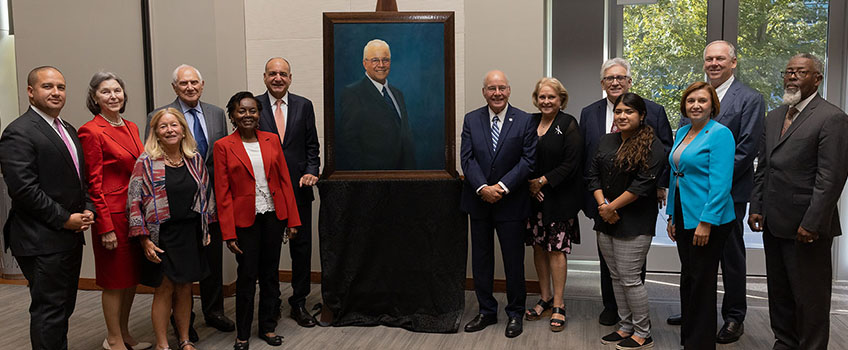 Stockton Board of Trustees with portrait of President Kesselman