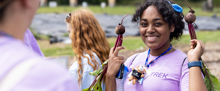 STEMinist camper holding a radish