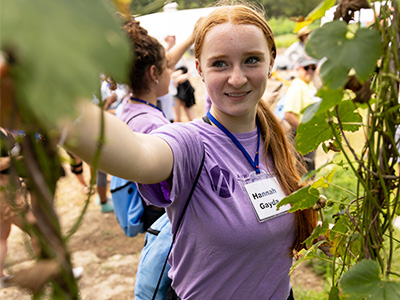 STEMinist camper looking at a grapevine