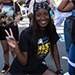 A T.A.L.O.N. poses in her Nest Fest t-shirt, excited to welcome new students to Stockton's overnight orientation experience.