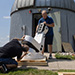 Physics Professor Joseph Trout helps unpack the new telescope this summer.