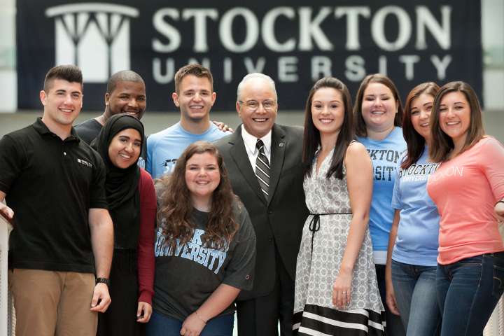 President Harvey Kesselman posing with Students