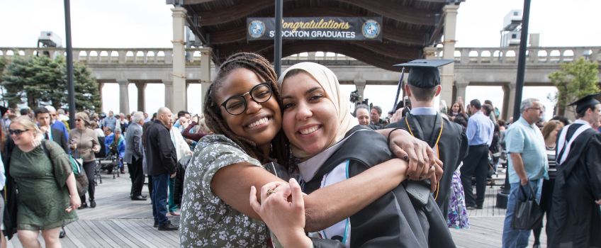 Graduating Political Science Student Hugging Friend