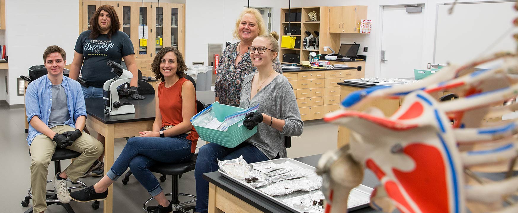 From left, Joseph Ross, Jennifer Rios, Professor Hornbeck, Anne LoDico and Carly Hammartstrom take a break from sifting through samples Hornbeck collected in the western Aleutian Islands of Alaska.