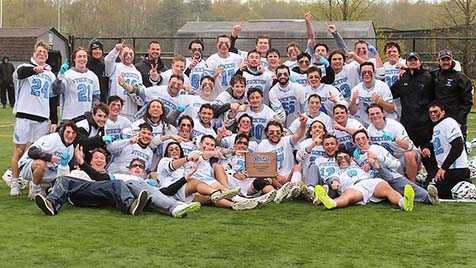 Men's Lacrosse team holding CSAC championship plaque on field