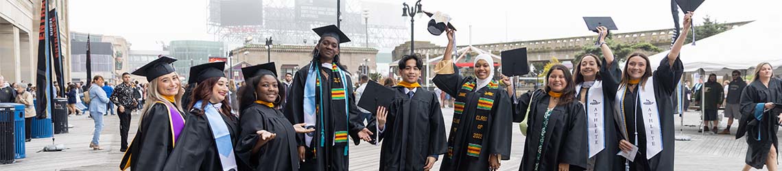 A group of graduates waving their caps on the Boardwalk