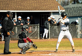An umpire, catcher, and batter at home plate