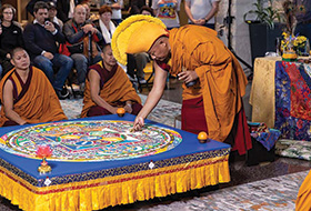 Tibetan Monks creating a sand mandala