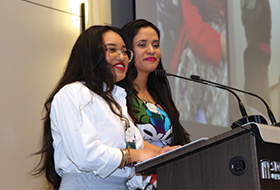 Bryanna Ortiz and Rubi Ortiz behind a podium