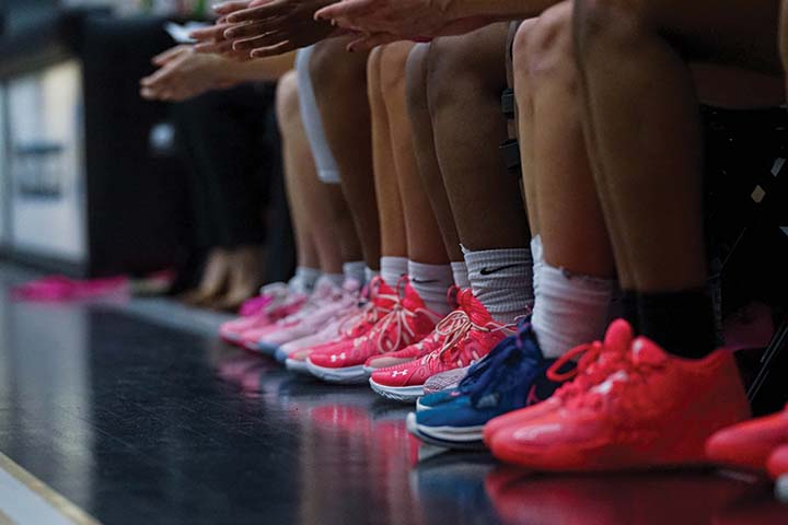 A close up of the pink sneakers worn by the women's basketball team