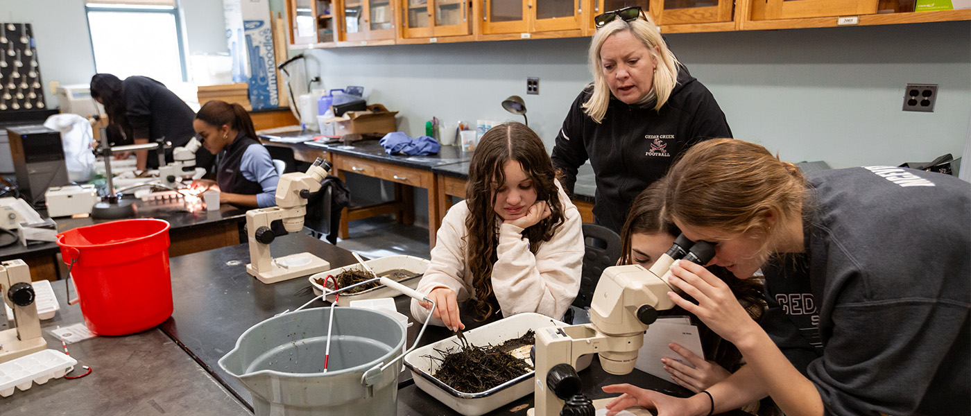 High school students at environmental science transfer day using science equipment in classroom at Stockton.