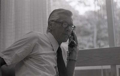 Woody Trombley using a landline phone, black and white