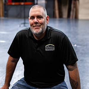 Man sitting on front of empty stage